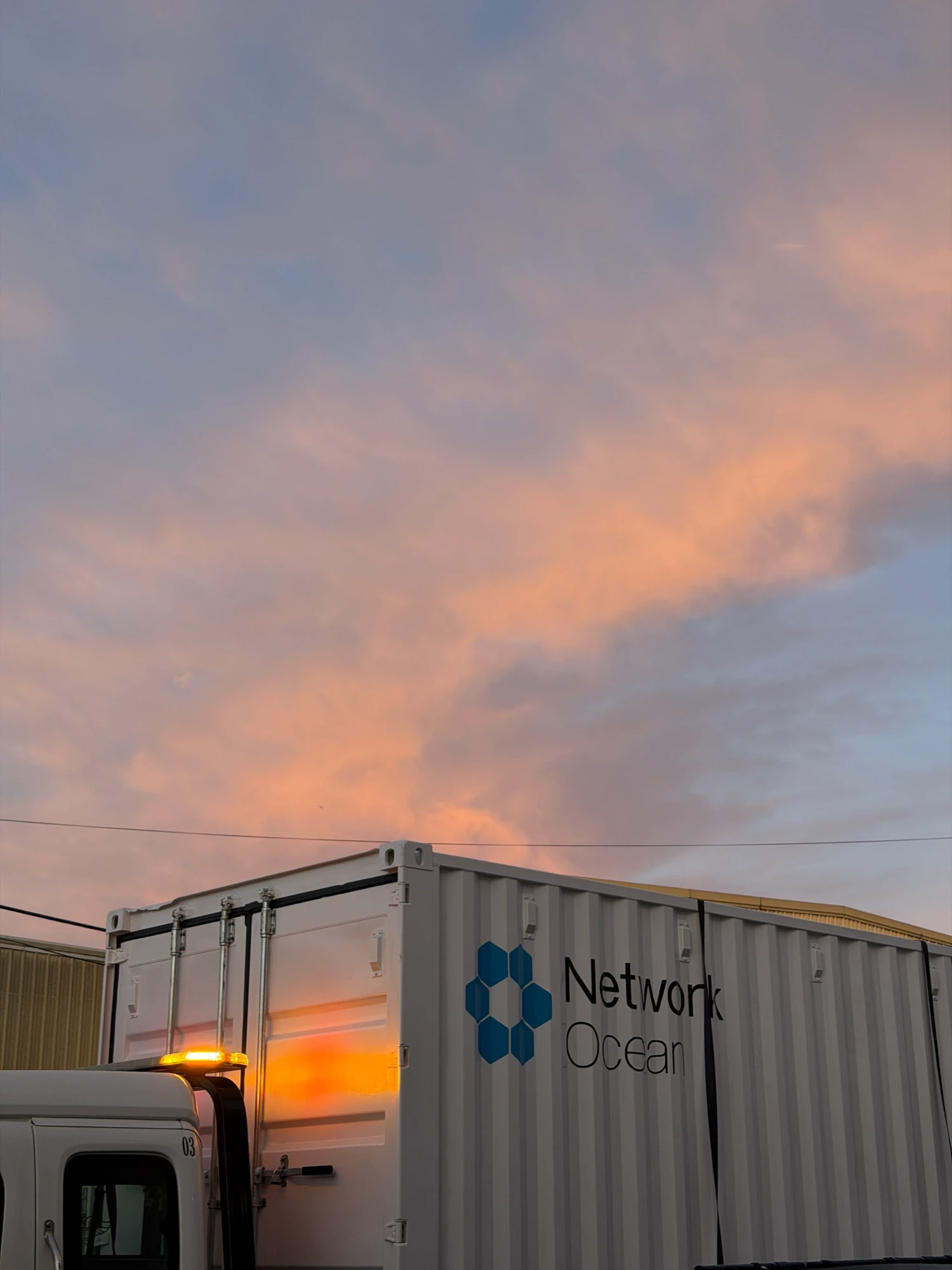 the data center container on a truck at sunset