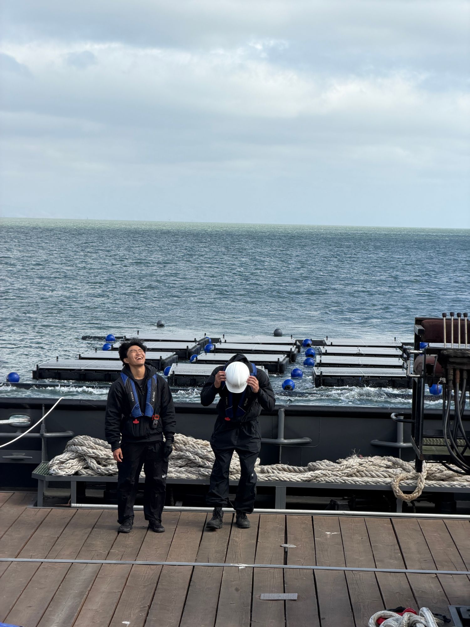 two of the crew on deck with the array afloat behind them